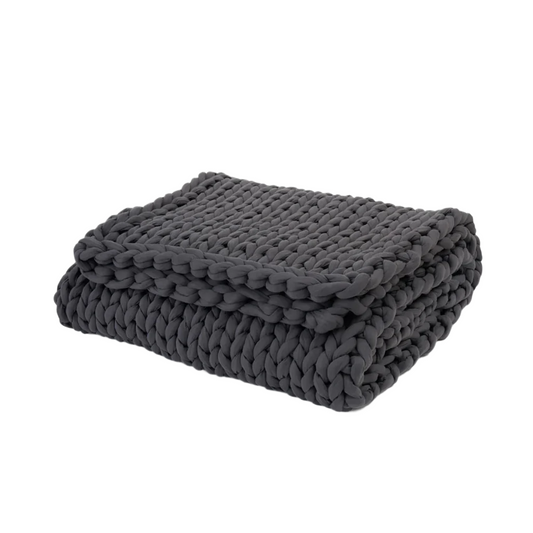 Folded dark gray knit blanket on a white background
